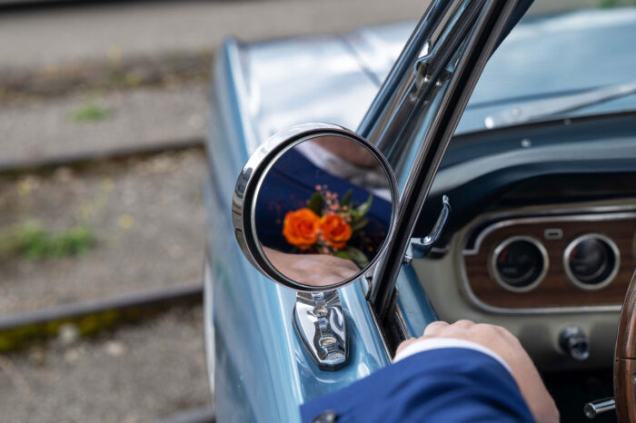 Seitenspiegel darin sehend Ansteckblume von Bräutigam